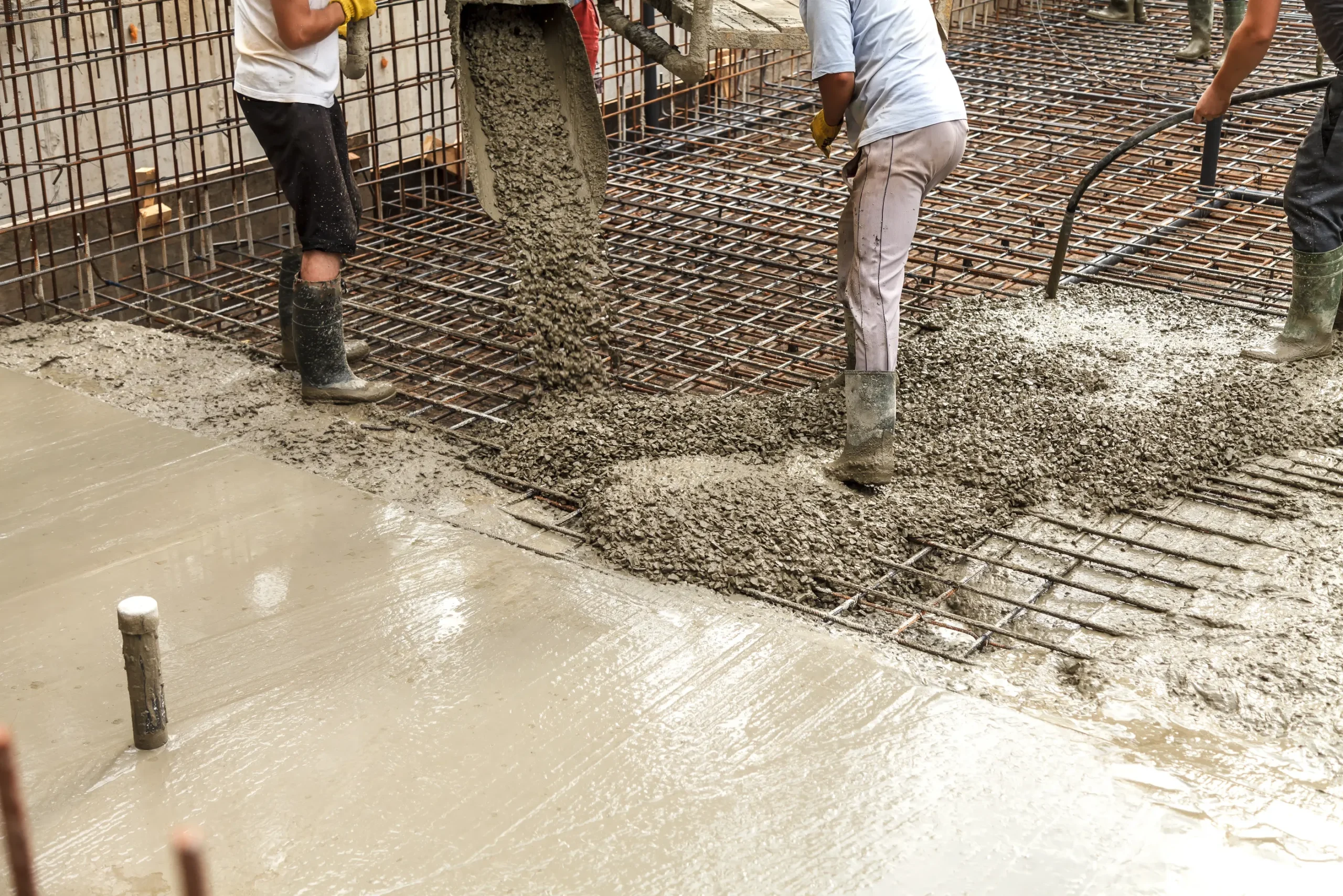 Concrete house work foundation being poured for new home construction.